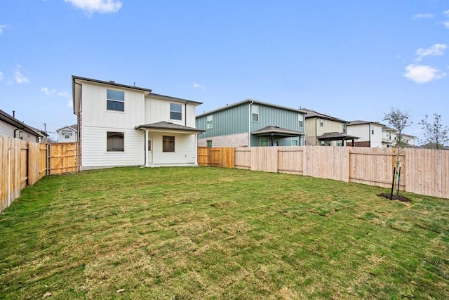 back of house with a lawn