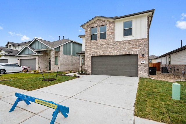 view of front of home with a front lawn, central AC unit, and a garage