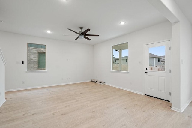 spare room featuring ceiling fan and light wood-type flooring