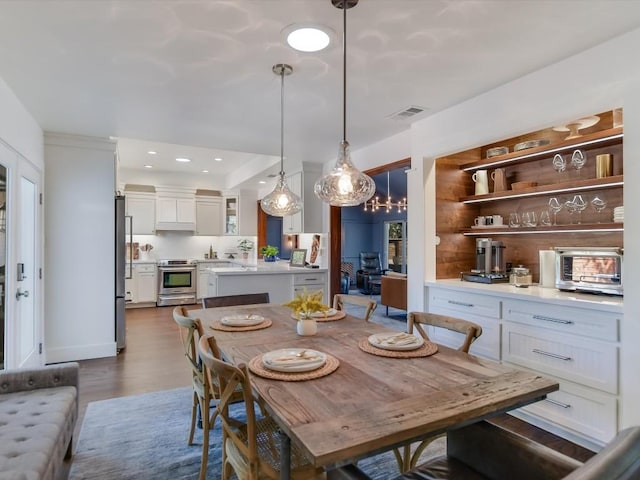 dining area featuring dark wood-type flooring