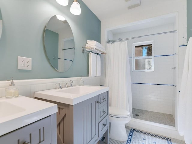 bathroom with toilet, a shower with curtain, vanity, and tile patterned floors