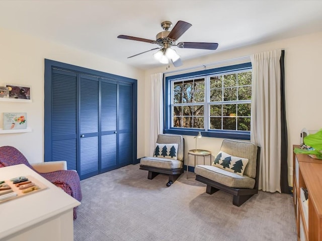 sitting room featuring carpet flooring and ceiling fan