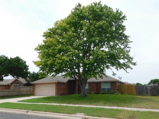 ranch-style house with a garage and a front yard