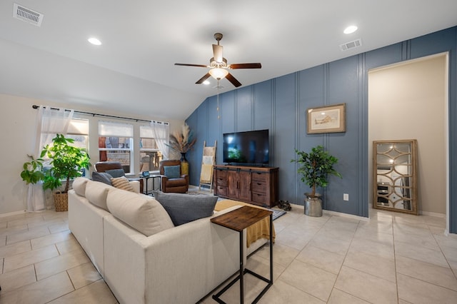 tiled living room with ceiling fan and vaulted ceiling