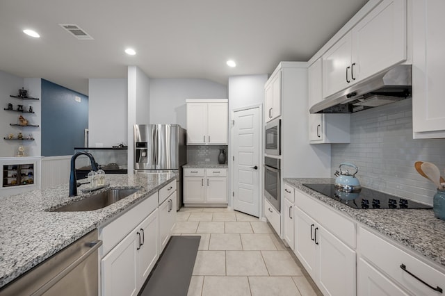 kitchen featuring light stone counters, stainless steel appliances, sink, white cabinetry, and light tile patterned flooring