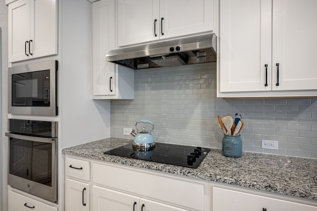 kitchen featuring black appliances, white cabinets, and backsplash