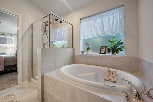 bathroom featuring tile patterned floors, separate shower and tub, and a wealth of natural light