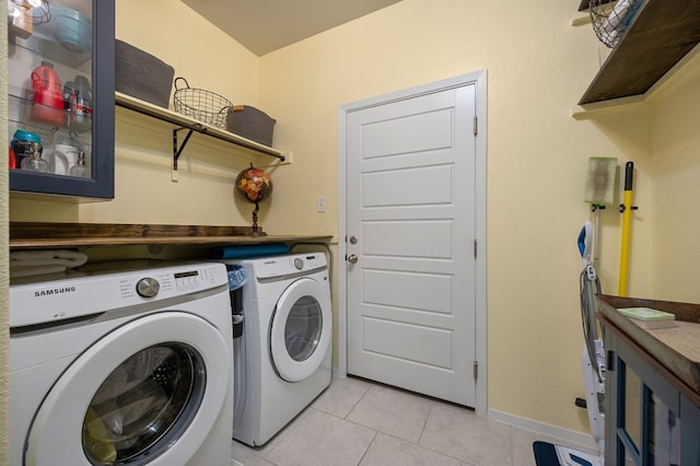 laundry room featuring independent washer and dryer and light tile patterned floors