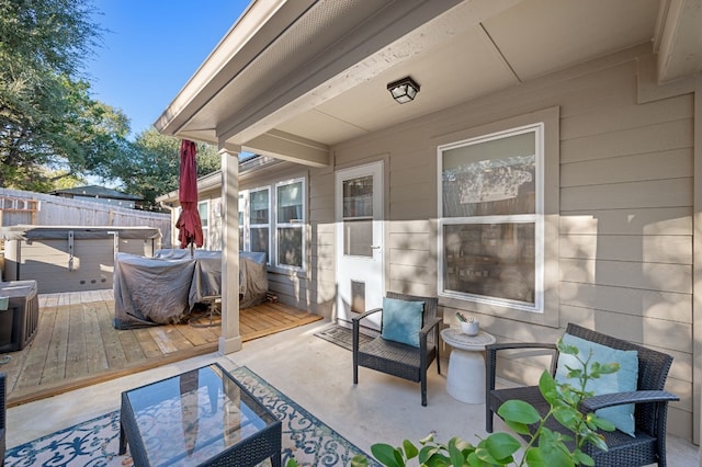 view of patio / terrace with area for grilling, a hot tub, and a deck