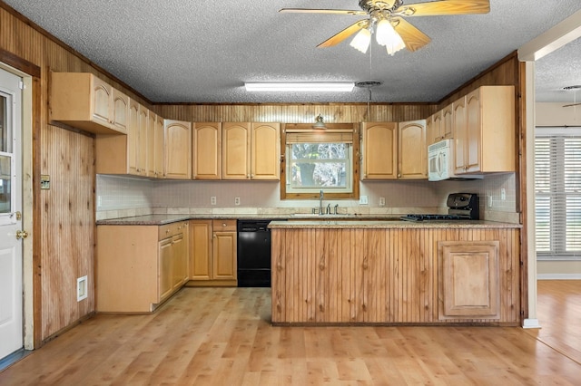 kitchen featuring kitchen peninsula, ceiling fan, black appliances, light brown cabinets, and light hardwood / wood-style flooring