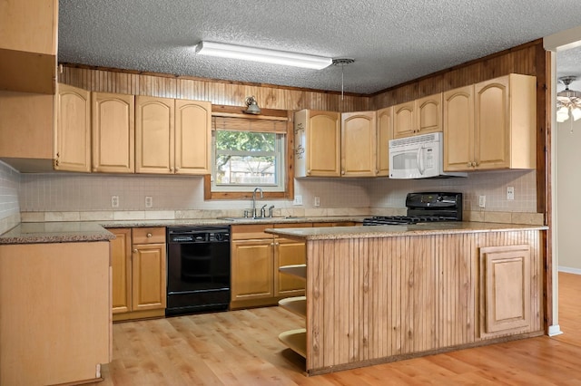 kitchen with light brown cabinets, sink, light hardwood / wood-style floors, a textured ceiling, and black appliances