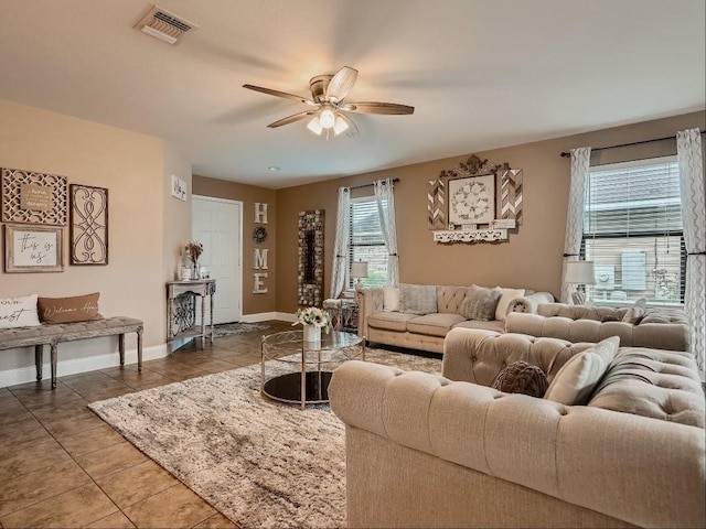 living room with ceiling fan and tile patterned flooring