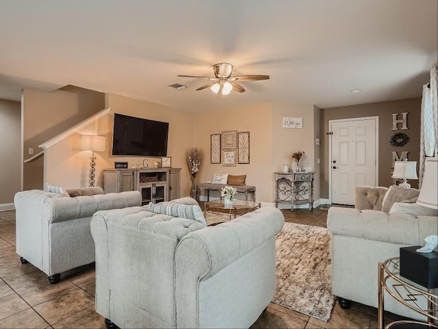 tiled living room featuring ceiling fan