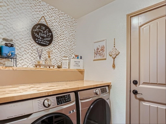 clothes washing area with washer and dryer