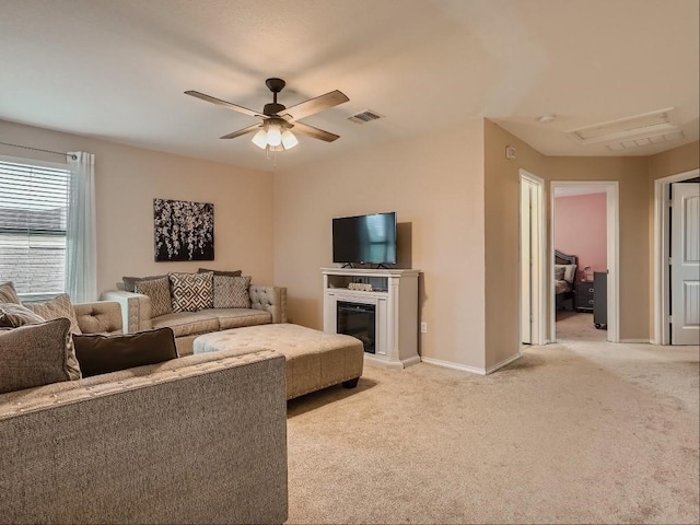 living room featuring ceiling fan and light colored carpet