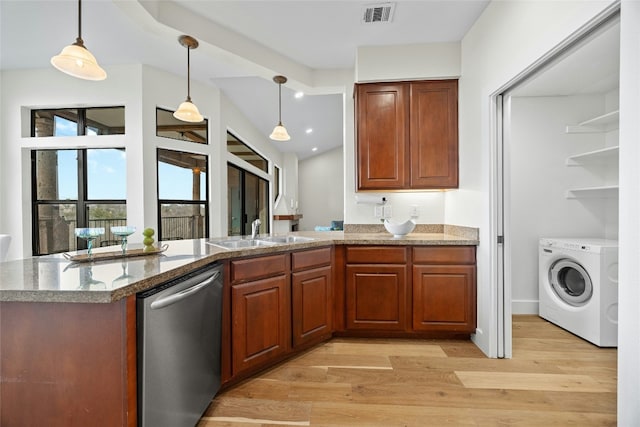 kitchen featuring sink, washer / clothes dryer, light wood-type flooring, stainless steel dishwasher, and pendant lighting