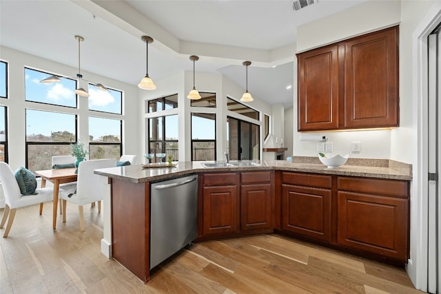 kitchen featuring kitchen peninsula, pendant lighting, sink, light hardwood / wood-style flooring, and stainless steel dishwasher