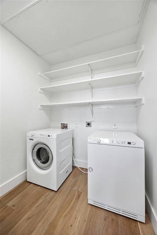 laundry room featuring light wood-type flooring, hookup for a washing machine, and electric dryer hookup