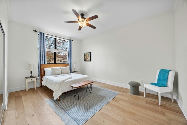 bedroom with ceiling fan, light hardwood / wood-style floors, and crown molding