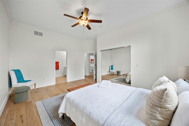 bedroom featuring ceiling fan, a closet, crown molding, and hardwood / wood-style floors