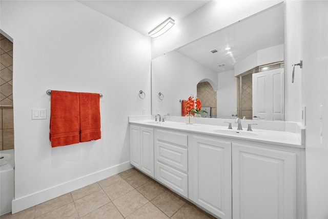 bathroom with walk in shower, tile patterned floors, and vanity