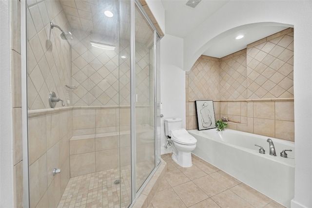 bathroom featuring independent shower and bath, tile walls, tile patterned floors, and toilet