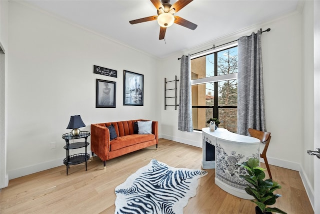 sitting room featuring ceiling fan, crown molding, and light hardwood / wood-style flooring