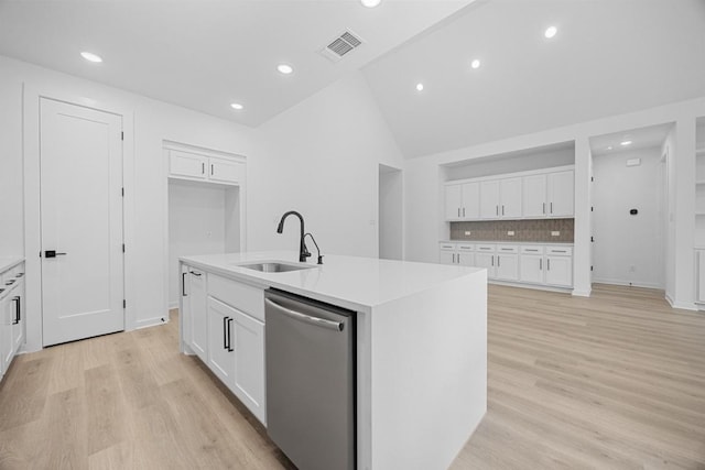 6000 Sean Paul Ln, Georgetown, TX 78628 - kitchen with stainless steel dishwasher, a center island with sink, light wood-style floors, white cabinets, and recessed lighting