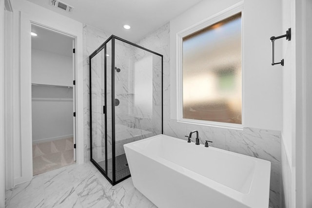 6000 Sean Paul Ln, Georgetown, TX 78628 - full bath featuring a freestanding bath, marble look tiles, a marble finish shower, a spacious closet, and recessed lighting