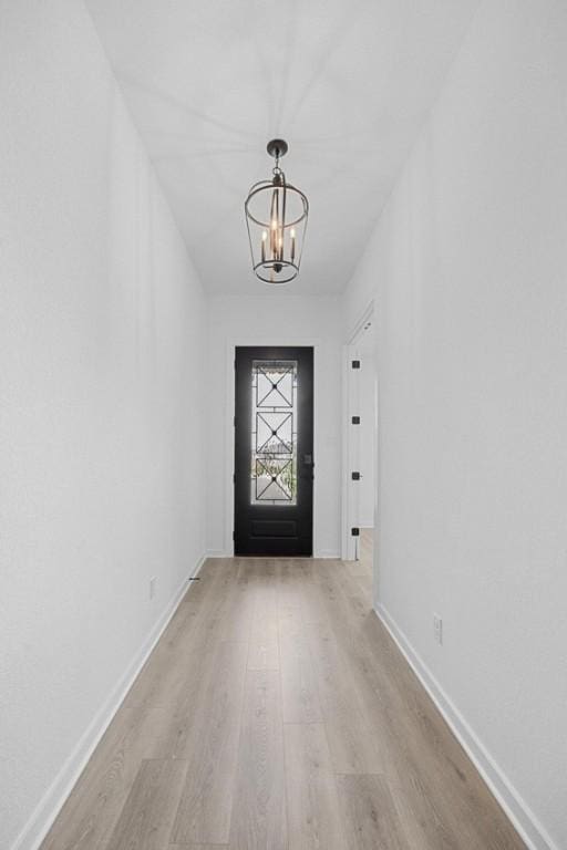 6000 Sean Paul Ln, Georgetown, TX 78628 - doorway with a chandelier and light wood finished floors