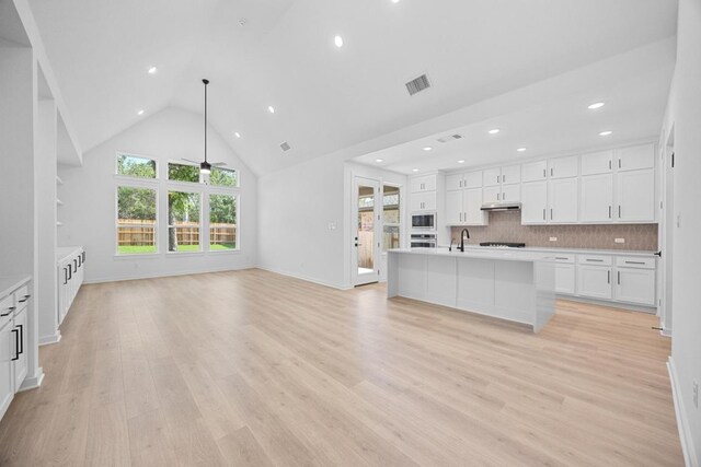 6000 Sean Paul Ln, Georgetown, TX 78628 - unfurnished living room with light wood-style flooring, recessed lighting, a ceiling fan, and high vaulted ceiling