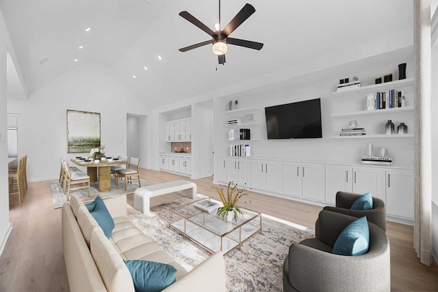 6000 Sean Paul Ln, Georgetown, TX 78628 - living area with light wood-type flooring, a ceiling fan, high vaulted ceiling, recessed lighting, and built in features