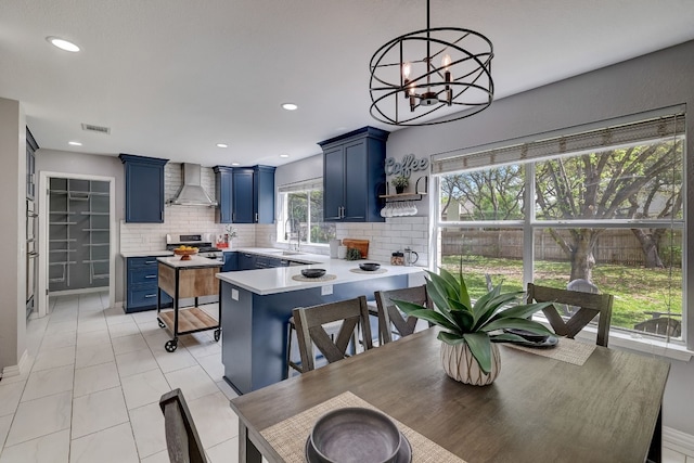 tiled dining area with a wealth of natural light, a notable chandelier, and sink