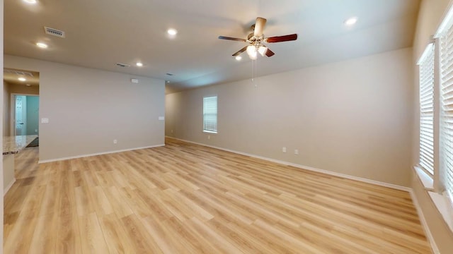 empty room with light hardwood / wood-style floors and ceiling fan