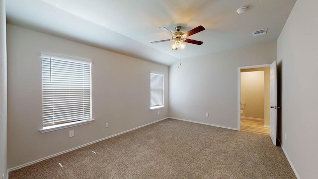 carpeted empty room featuring ceiling fan and lofted ceiling