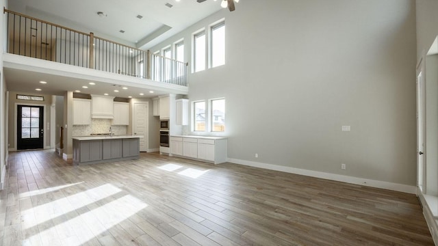 5612 Kyle Joseph Dr, Georgetown, TX 78628 - unfurnished living room with light wood-style floors and a high ceiling