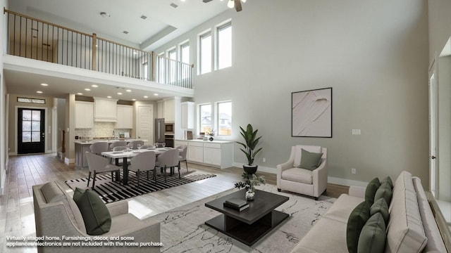 5612 Kyle Joseph Dr, Georgetown, TX 78628 - living area featuring a high ceiling, light wood-style floors, and recessed lighting