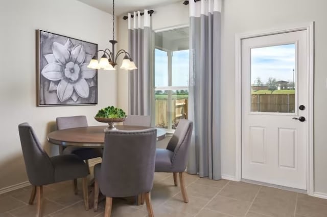 dining area featuring an inviting chandelier and light tile patterned flooring