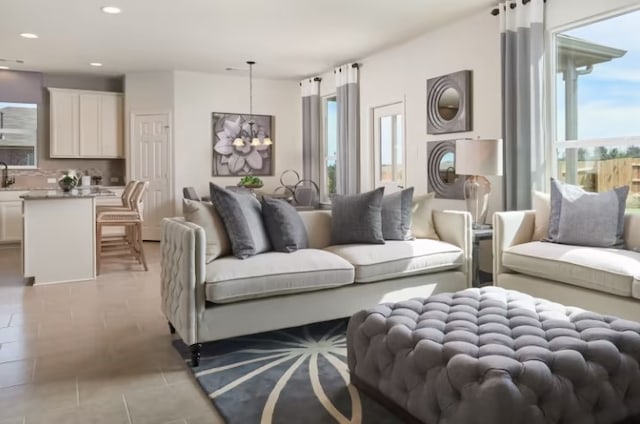 living room featuring a notable chandelier and sink