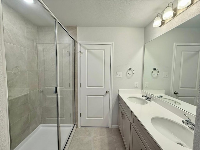 bathroom featuring tile patterned flooring, vanity, and an enclosed shower