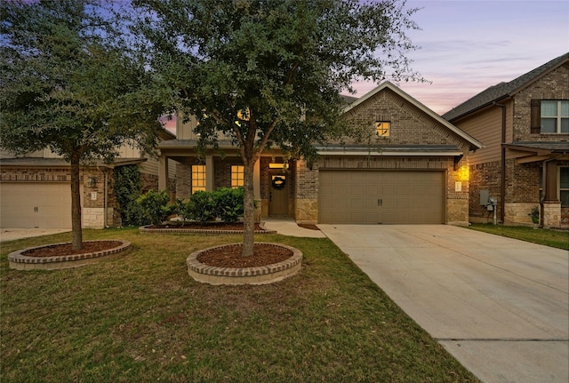 view of front of home with a yard and a garage