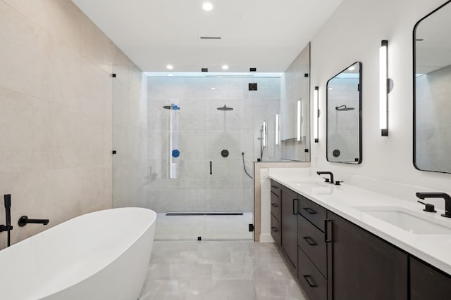 bathroom with shower with separate bathtub and vanity