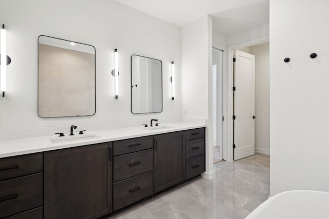 bathroom featuring vanity and a washtub