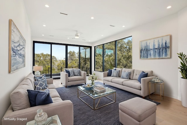 living room featuring hardwood / wood-style flooring and ceiling fan