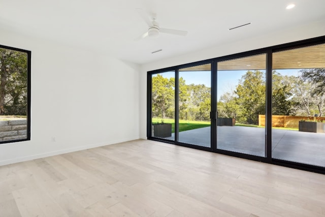 unfurnished room with light hardwood / wood-style flooring and ceiling fan