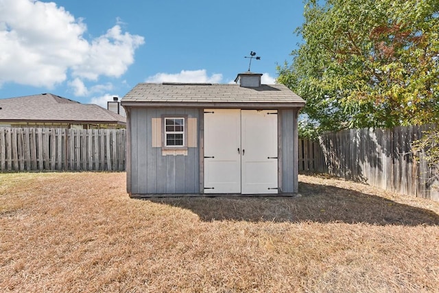 view of outbuilding with a yard