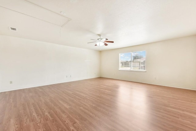 empty room featuring ceiling fan and light hardwood / wood-style floors