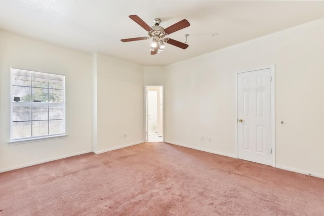 spare room with ceiling fan and light colored carpet