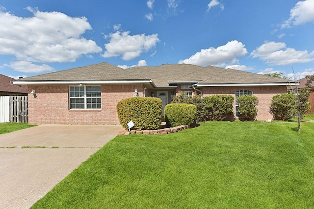 ranch-style home with a front lawn, concrete driveway, and brick siding