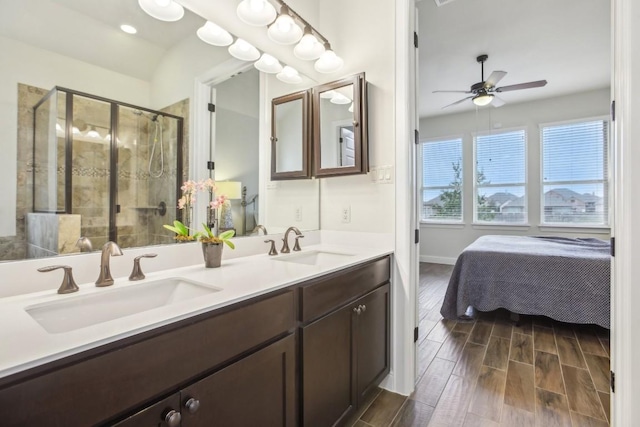 bathroom featuring ceiling fan, vanity, and an enclosed shower